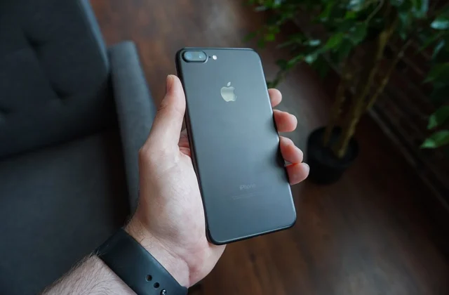 Close-up of a hand holding a smartphone, representing mobile data connectivity while traveling